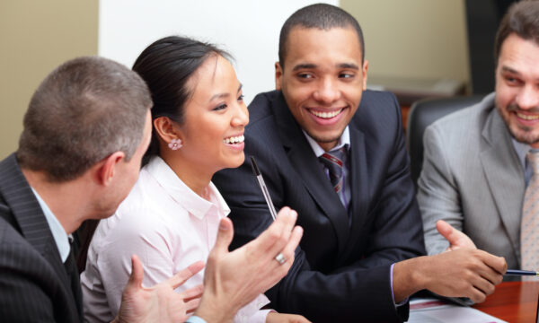 Multi ethnic business team at a meeting. Interacting. Focus on woman