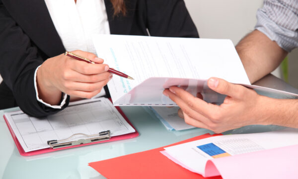 People at table reviewing presentation document