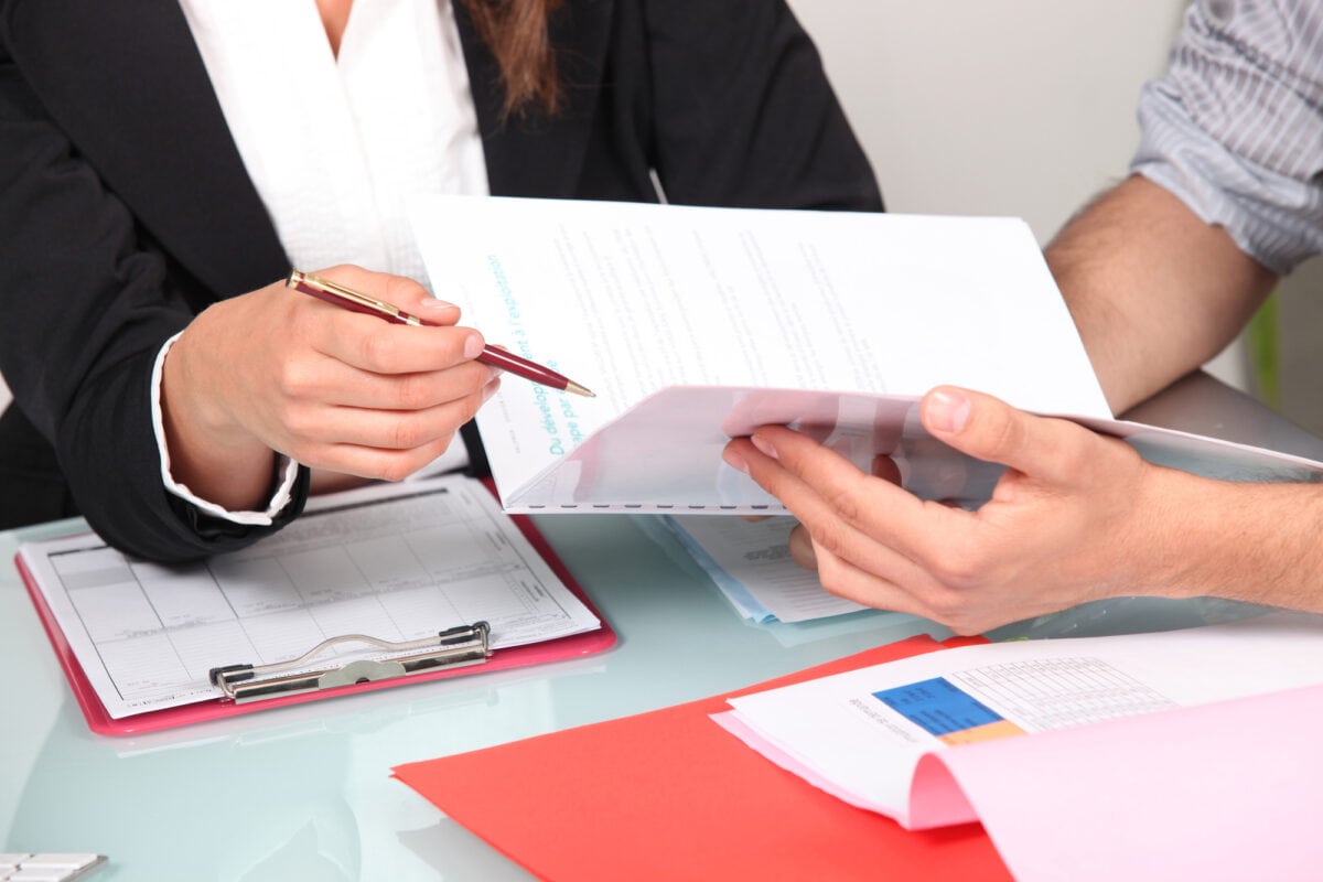 People at table reviewing presentation document