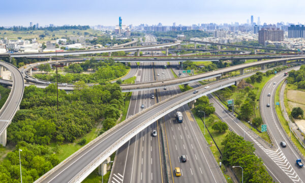 intersecting highways in front of city scape