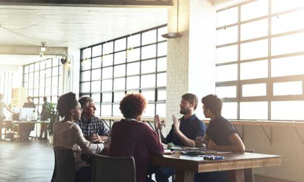 people talking in a work group at a table