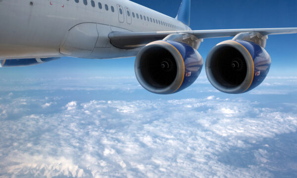 plane wing flying over clouds