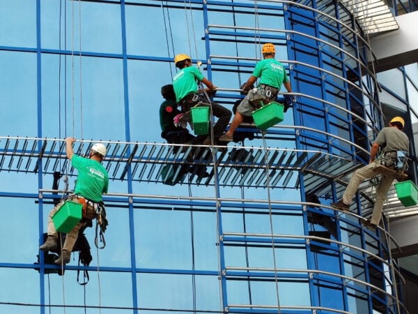 window washers on wires cleaning glass